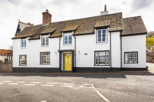 Double-fronted cottage exterior with traditional quarter-light windows.