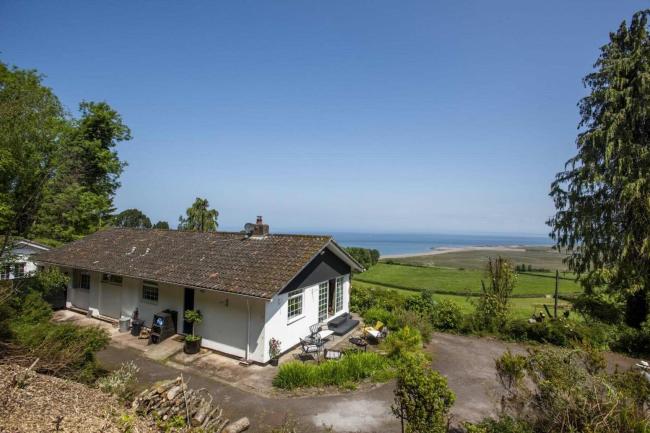 A modern bungalow in an elevated remote rural location wit sea views. 