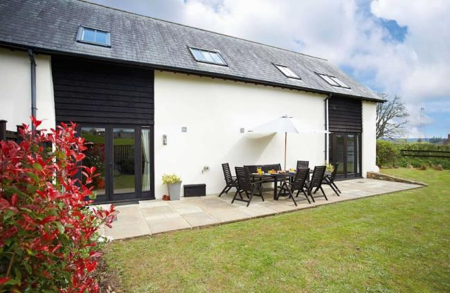 A large single storey barn with a private, secure, hedge-lined lawn.