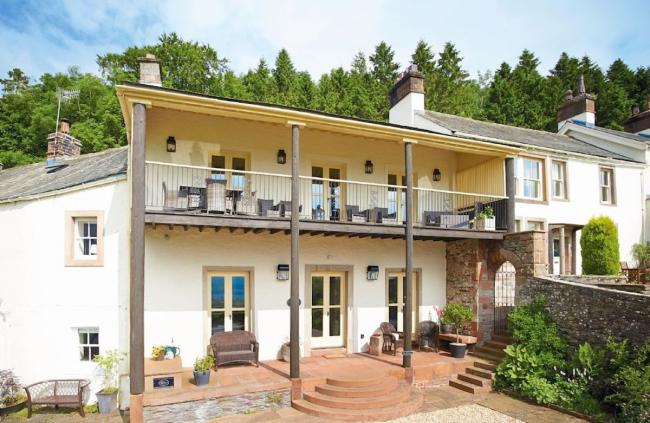 Ulleswater holiday cottage with a full length balcony and front terrace.