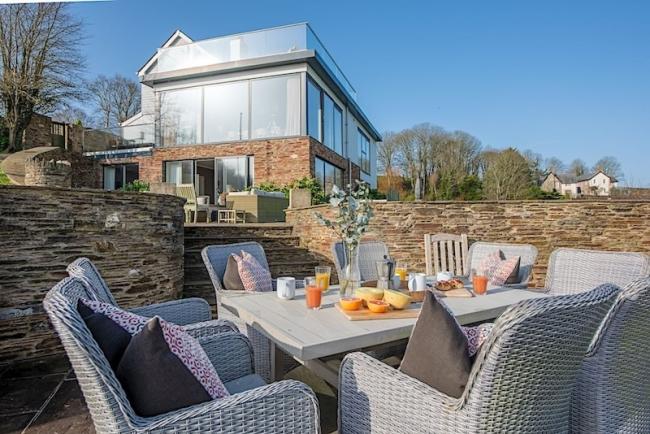 Luxury holiday home with 1st floor being all windows with a roof terrace above.