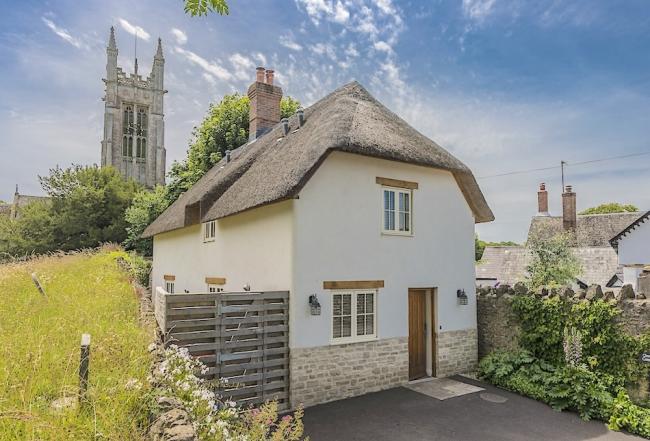 Exterior of a thatched village cottage in Dorset.