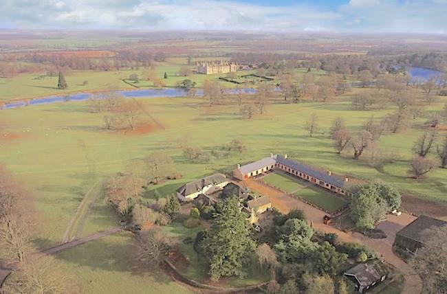 Aerial view of the flat Lincolnshire countryside with a group of luxury stable conversions surrounding a large courtyard.