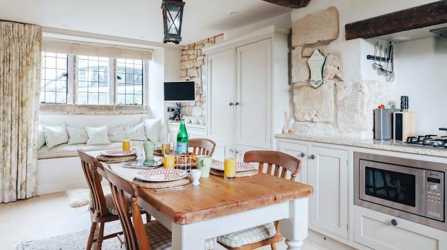 Cotswold cottage kitchen with a dining table.