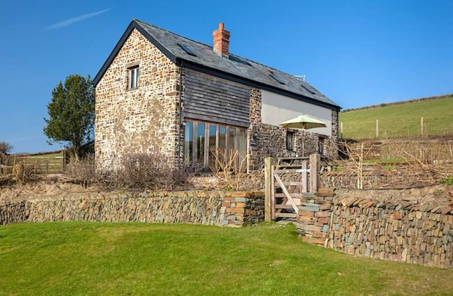 A stone-built Exmoor barn conversion in open countryside.