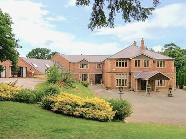 A large and rambling, brick-built country house and wing overlooks the Denbighshire countryside