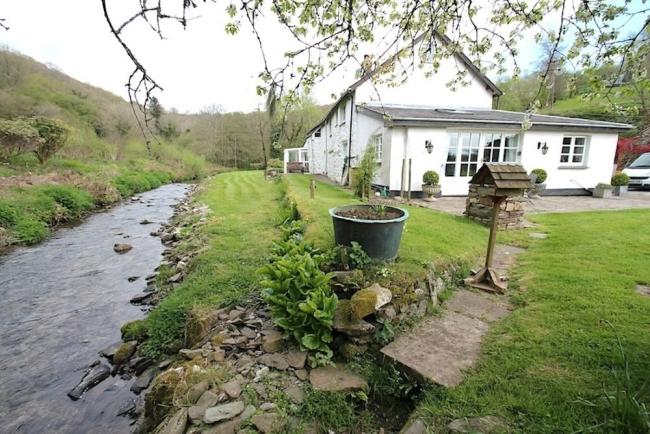 A North Devon riverside cottage with a large lawn.