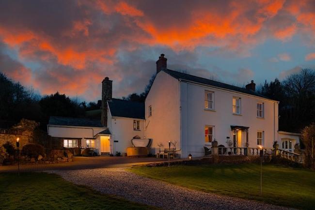 A large country house at dusk.