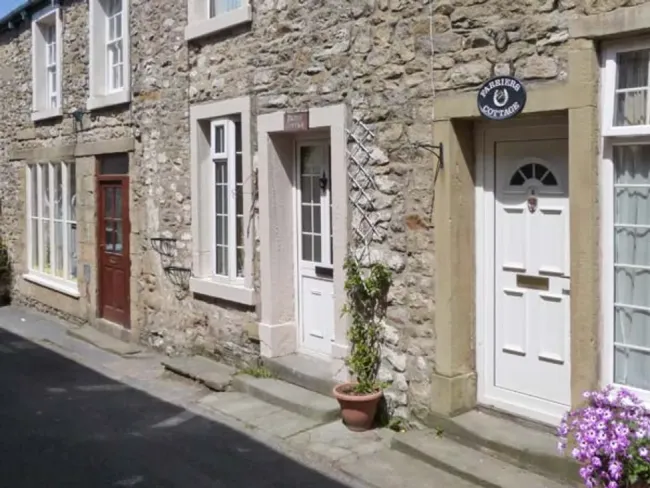 Ground floor street exterior of a stone-built terraced holiday cottage in Settle