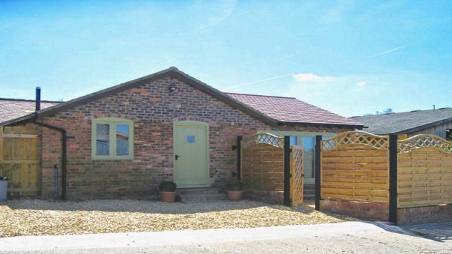 A single-storey bungalow with an off-road parking space for two cars.