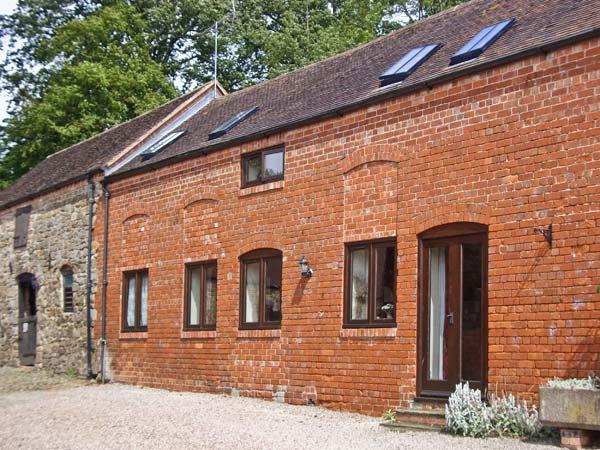 Exterior of a brick-built Shropshire barn conversion with a courtyard.