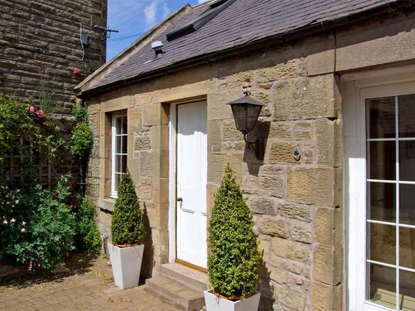 Exterior  of a stone-built, single-storey Chirnside holiday cottage.