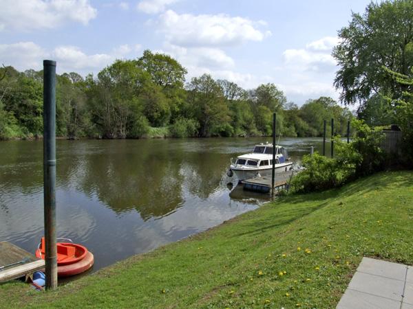 A lawn slope down boat moored on the banks of the River Severn