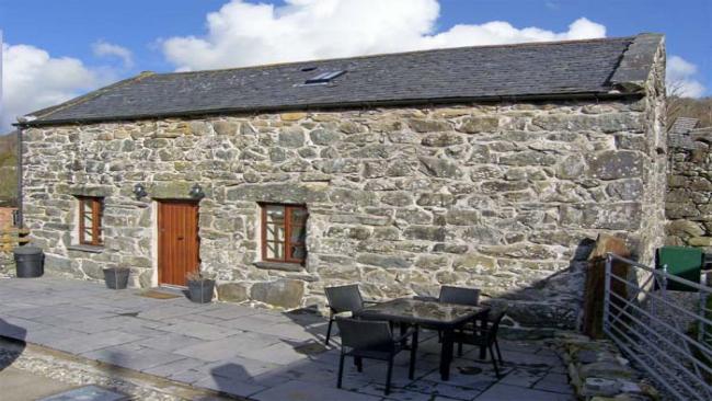 A long, stone-built, single storey, courtyard barn conversion in Gwynedd