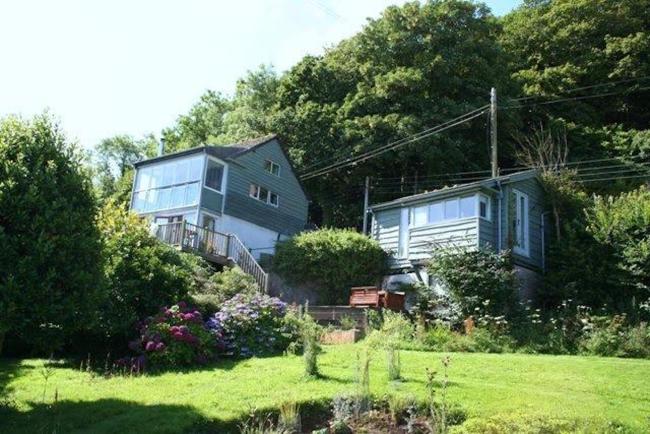 Country Cottage with large garden overlooked by a steep, wooded hill