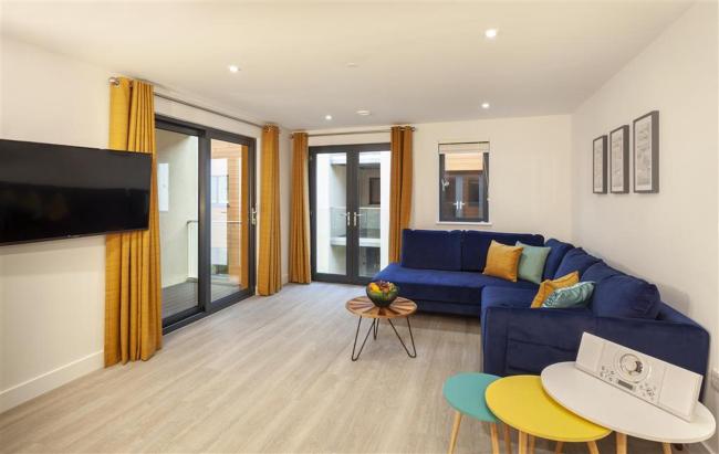 Spacious, open-Plan interior of a modern seaside holiday apartment.