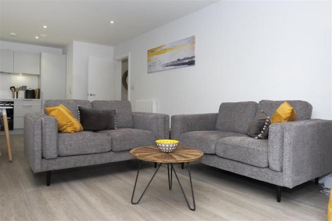 Comfortable cotton sofas in an open-plan living area