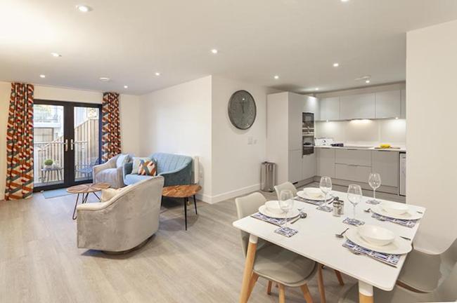 Open-plan living areas in a holiday apartment with French doors to a balcony.