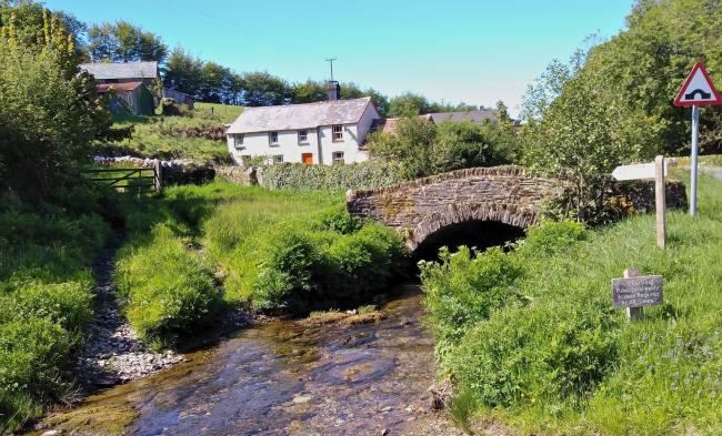 Challacombe in North Devon An ancient packhorse bridge crosses the Bray River.