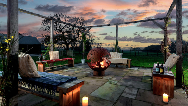 A Yorkshire Wolds Sunset Near Beverley Holiday cottages in the Yorkshire Wolds: The terrace at Broadgate Farm in the sunset - A Luxury Holiday Cottage.